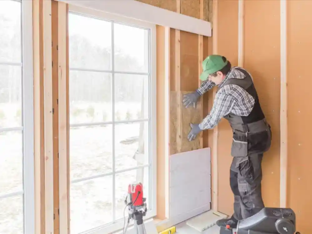 Technician installing plywood board-up over a damaged window or door frame — Emergency Board Up Post Fire in Fairfax, VA