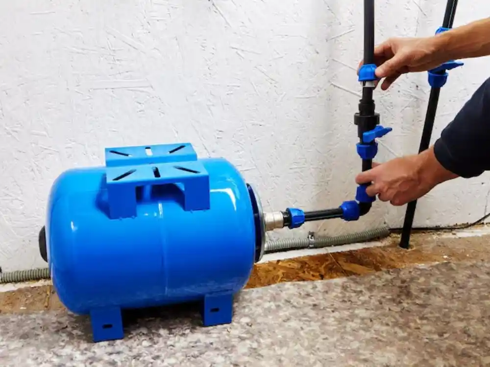 Technician installing or servicing a sump pump unit in a basement pit — Emergency Sump Pump Installation Repair in Fairfax, VA