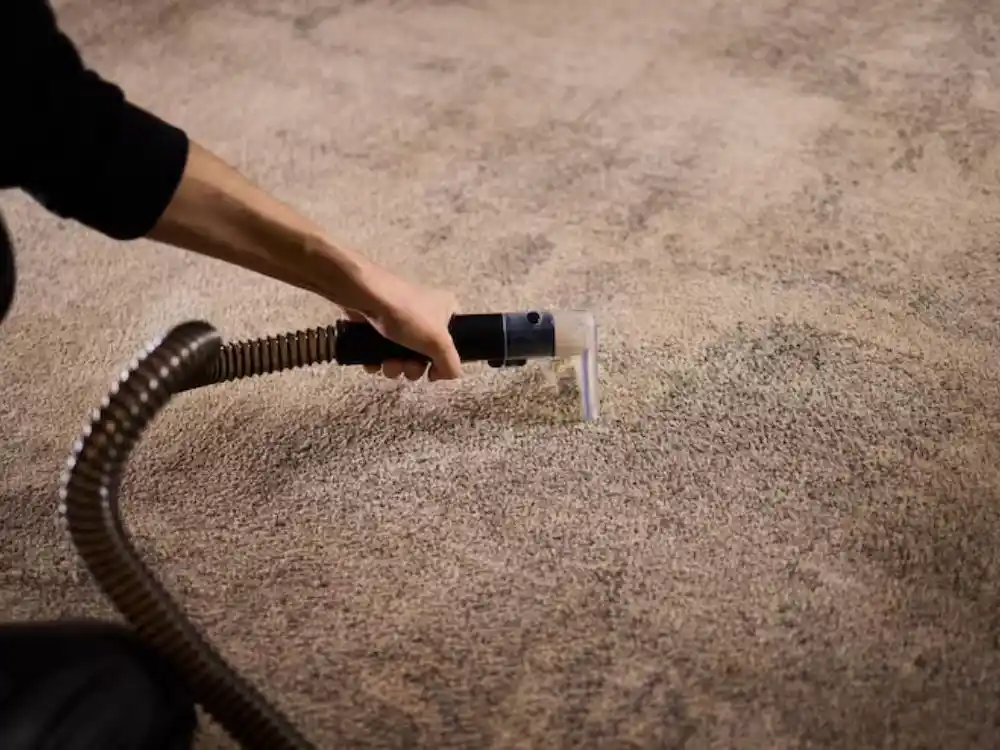 Technician operating a truck-mounted water extraction wand on wet carpet or flooring — Emergency Water Extraction in Fairfax, VA