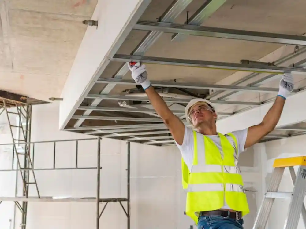 Contractor/technician installing new drywall or framing during a structural rebuild phase — Full Structural Restoration in Fairfax, VA